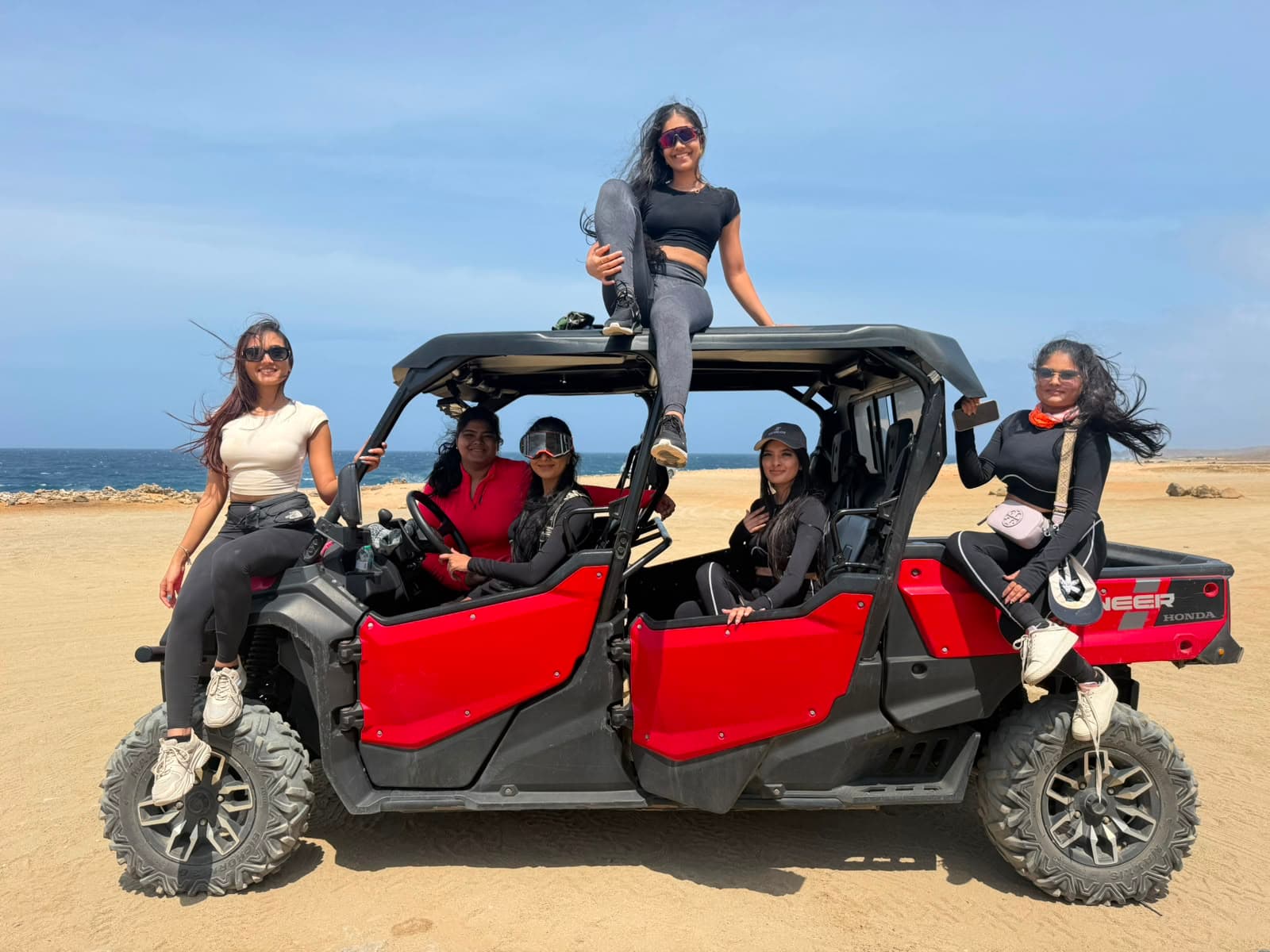 Guests with a 6-seat Honda Pioneer UTV on Aruba's north coast